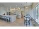 Bright kitchen features an eat-in island, light wood floors, updated appliances, and a charming breakfast nook at 9520 Sundial Dr, Las Vegas, NV 89134