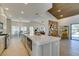 Kitchen features an island, stainless steel appliances, modern countertops, and seamless access to the living and dining spaces at 9520 Sundial Dr, Las Vegas, NV 89134
