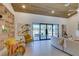 Bright living room boasting a wood ceiling, stylish decor, and a wall of windows with views of the outdoor area at 9520 Sundial Dr, Las Vegas, NV 89134