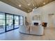 Open living room with a fireplace, sleek furniture, and expansive glass doors leading to an outdoor patio at 9520 Sundial Dr, Las Vegas, NV 89134