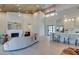 Modern living room with a fireplace, high ceilings, and an open-concept design connected to the kitchen and dining area at 9520 Sundial Dr, Las Vegas, NV 89134