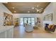 Bright living room featuring wood ceiling, open shelving, modern decor, and large windows to the backyard at 9520 Sundial Dr, Las Vegas, NV 89134