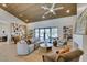 Bright living room featuring wood ceiling, open shelving, modern decor, and large windows to the backyard at 9520 Sundial Dr, Las Vegas, NV 89134