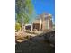 View of a two-story home and backyard featuring a covered patio and desert landscaping under a blue sky at , Henderson, NV 89052