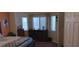 Bright bedroom featuring a dresser, lots of light from three windows, and modern decor with neutral colors at , Henderson, NV 89052
