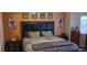 Well-decorated bedroom with a large upholstered headboard and a patchwork comforter. Features modern decorations and paint at , Henderson, NV 89052