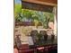 Outdoor patio showcasing a metal table and chairs set against the backdrop of a well-kept backyard at , Henderson, NV 89052