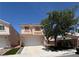 Two story single Gathering home featuring stucco exterior, concrete driveway and front yard featuring mature shade tree at , Henderson, NV 89052
