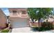 Two story single Gathering home featuring stucco exterior, concrete driveway and front yard featuring mature shade tree at , Henderson, NV 89052