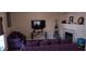 Comfortable living room with plush sofas, dark wood floors, and a wall-mounted TV for entertainment at , Henderson, NV 89052