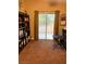 Cozy home office with carpet flooring, built-in bookcase, and a sliding glass door leading to outdoor space at , Henderson, NV 89052