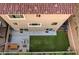Aerial view of a backyard showing the patio, artificial grass, and surrounding fence lines at 10047 Alden Creek St, Las Vegas, NV 89141