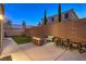 Spacious backyard featuring a patio, artificial grass, and a privacy wall, ideal for outdoor gatherings and relaxation at 10047 Alden Creek St, Las Vegas, NV 89141