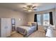 This carpeted bedroom is well lit with two windows and has a ceiling fan and closet for ample storage space at 10047 Alden Creek St, Las Vegas, NV 89141