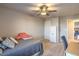 This carpeted bedroom has a ceiling fan, storage closet, and chair providing a comfortable and functional space at 10047 Alden Creek St, Las Vegas, NV 89141