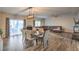 Open dining area with wood floors, stylish chandelier, and a view of the living space, perfect for entertaining at 10047 Alden Creek St, Las Vegas, NV 89141
