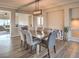 Dining room with a view into the living area, complemented by modern lighting and stylish furniture, perfect for gatherings at 10047 Alden Creek St, Las Vegas, NV 89141