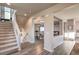 Inviting entryway featuring hardwood floors, staircase, and open view into the dining area, creating a warm welcome at 10047 Alden Creek St, Las Vegas, NV 89141