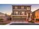 Two-story home features a balcony, three-car garage, and meticulously manicured front yard at 10047 Alden Creek St, Las Vegas, NV 89141