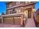 Charming two-story home with three-car garage, landscaped front yard and covered porch at 10047 Alden Creek St, Las Vegas, NV 89141