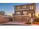 Charming two-story home featuring a balcony, three-car garage, and landscaped front yard at 10047 Alden Creek St, Las Vegas, NV 89141