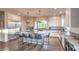 Open concept kitchen with seating for seven at the island, a stainless steel refrigerator and modern oven at 10047 Alden Creek St, Las Vegas, NV 89141