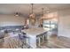 Spacious kitchen island, stainless steel refrigerator and open concept to the living area at 10047 Alden Creek St, Las Vegas, NV 89141
