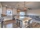 Open-concept kitchen and living area featuring a large island and stainless steel appliances at 10047 Alden Creek St, Las Vegas, NV 89141