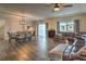 Open-concept living and dining areas, featuring hardwood floors, creating a spacious and connected living space at 10047 Alden Creek St, Las Vegas, NV 89141