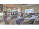 Open-concept living space featuring a kitchen island with bar stools and a comfortable sectional sofa, great for gatherings at 10047 Alden Creek St, Las Vegas, NV 89141