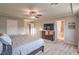 Light-filled main bedroom with neutral carpet, a large TV, and ensuite bathroom access at 10047 Alden Creek St, Las Vegas, NV 89141