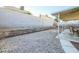 A patio offers space for outdoor dining and entertaining in this yard with minimal landscaping at 1012 Greystone Dr, Las Vegas, NV 89108