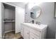 Modern bathroom with a white vanity, a stylish mirror, and wood floors at 1012 Greystone Dr, Las Vegas, NV 89108