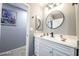 Modern bathroom featuring a white vanity, new fixtures, and a round mirror, offering a clean and stylish aesthetic at 1012 Greystone Dr, Las Vegas, NV 89108