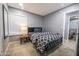 Cozy bedroom features a queen-sized bed, warm lighting, and a tiled floor at 1012 Greystone Dr, Las Vegas, NV 89108