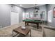 Bright game room features a pool table, neutral paint, ceiling fan, and wood-style tile flooring at 1012 Greystone Dr, Las Vegas, NV 89108