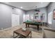 A spacious game room offers entertainment with a pool table, comfortable seating, and stylish decor at 1012 Greystone Dr, Las Vegas, NV 89108