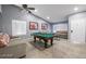 Bright game room showcases a pool table, neutral paint, vaulted ceiling and wood-style tile flooring at 1012 Greystone Dr, Las Vegas, NV 89108