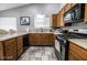 Traditional kitchen features warm wood cabinets, tile floors, stainless steel appliances, and natural light at 1012 Greystone Dr, Las Vegas, NV 89108