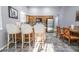 Kitchen with an eat-in area features bar seating, wood cabinets, stainless appliances, and unique flooring at 1012 Greystone Dr, Las Vegas, NV 89108