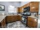Modern kitchen featuring stainless steel appliances, wood cabinets, and a white countertop at 1012 Greystone Dr, Las Vegas, NV 89108