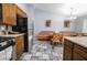 Open kitchen and dining area includes wood cabinets, stainless steel appliances, and stylish tile flooring at 1012 Greystone Dr, Las Vegas, NV 89108