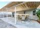 Inviting covered patio with dining set offers an ideal outdoor entertaining and relaxing space at 1012 Greystone Dr, Las Vegas, NV 89108