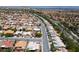 A neighborhood aerial shot with wide streets and uniform houses under a clear sky at 10301 Bent Brook Pl, Las Vegas, NV 89134