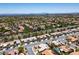 Wide aerial of a neighborhood with well-manicured lawns and community pool in the distance at 10301 Bent Brook Pl, Las Vegas, NV 89134