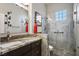 Bathroom featuring a granite countertop, framed mirror, and shower at 10301 Bent Brook Pl, Las Vegas, NV 89134