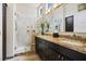 Bathroom showcasing granite countertop, dual sinks, and tiled walk-in shower at 10301 Bent Brook Pl, Las Vegas, NV 89134