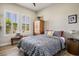 Comfortable bedroom with wood floors, windows, furniture, and decor at 10301 Bent Brook Pl, Las Vegas, NV 89134