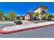 Neutral-toned building exterior with well-manicured landscaping, sidewalks, and ample parking spots for convenient access at 10301 Bent Brook Pl, Las Vegas, NV 89134