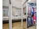 Mirrored closet door reveals clothing in walk-in closet and large bedroom at 10301 Bent Brook Pl, Las Vegas, NV 89134